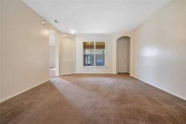 a view of empty room with windows