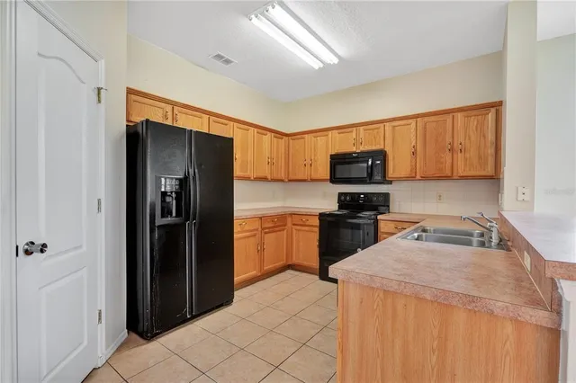 a kitchen with granite countertop a refrigerator and a sink