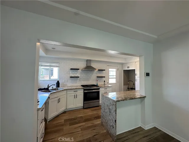 a kitchen with stainless steel appliances granite countertop a sink and stove top oven
