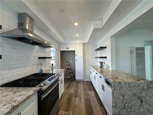 a large kitchen with a stove and a sink