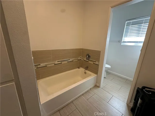 a bathroom with a tub a sink and a shower