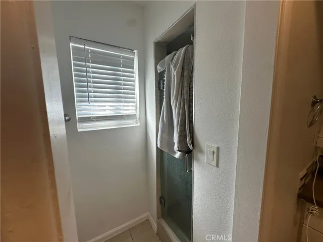 a bathroom with a window and a shower
