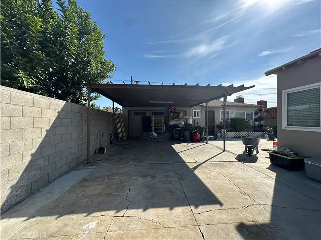 a view of a patio with table and chairs with wooden floor and fence