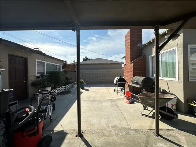 a room with lots of potted plants and wooden floor