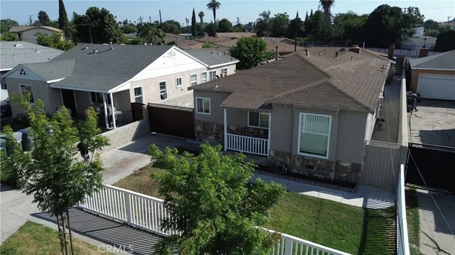 an aerial view of a house with garden space and street view