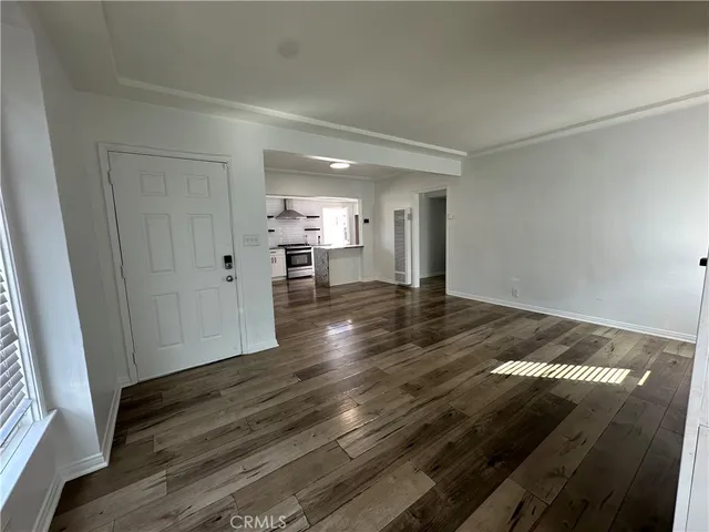 a view of an empty room and wooden floor