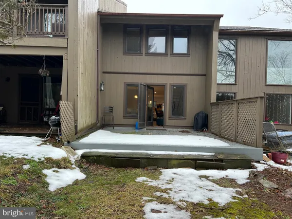 a view of a house with wooden fence
