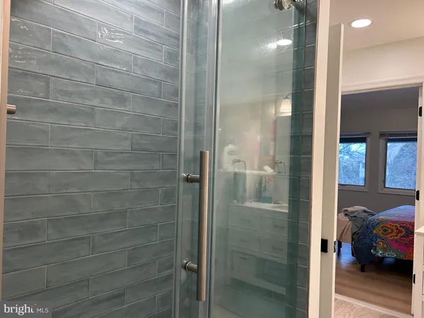 a bathroom with a shower a mirror and a shower