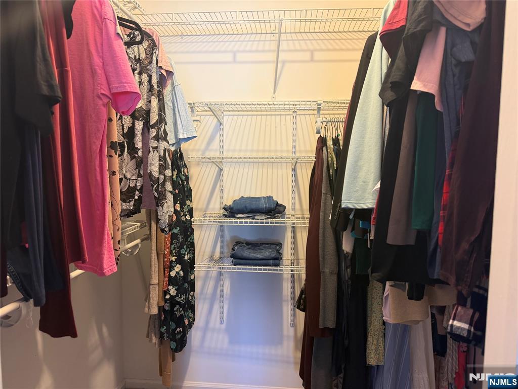 2308 Hemingway Lane, Unit 2308 Mahwah, NJ 07430 - Photo 15 of 16 a view of walk in closet with clothes