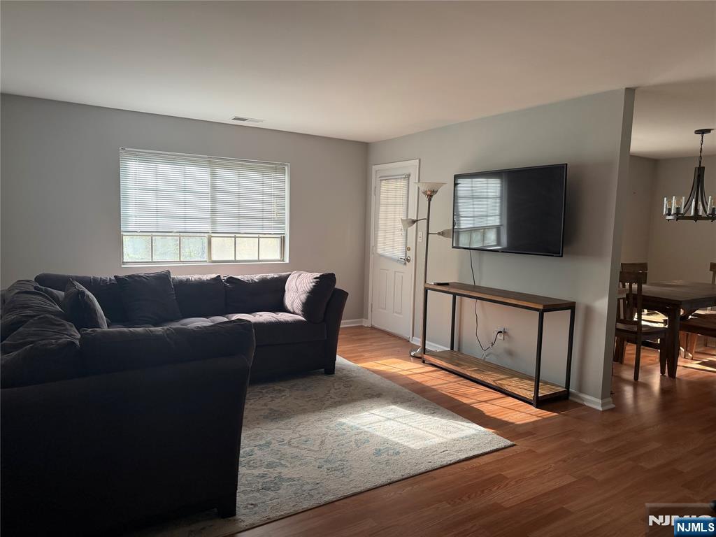 2308 Hemingway Lane, Unit 2308 Mahwah, NJ 07430 - Photo 5 of 16 a living room with furniture and a flat screen tv