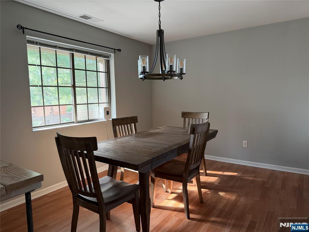 2308 Hemingway Lane, Unit 2308 Mahwah, NJ 07430 - Photo 6 of 16 a view of a dining room with furniture window and wooden floor