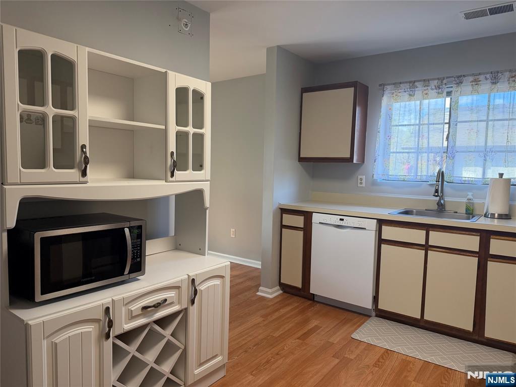 2308 Hemingway Lane, Unit 2308 Mahwah, NJ 07430 - Photo 7 of 16 a kitchen with a stove microwave and sink