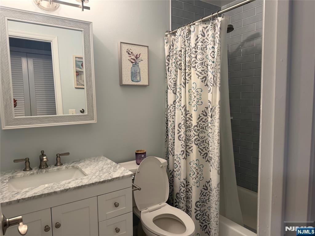 2308 Hemingway Lane, Unit 2308 Mahwah, NJ 07430 - Photo 10 of 16 a bathroom with a granite countertop sink toilet and shower