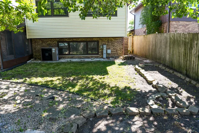 a backyard of a house with a garden and outdoor seating