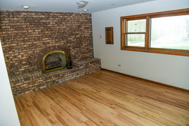 a room with wooden floor and a window