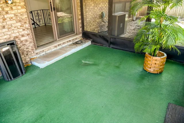 a backyard of a house with table and chairs