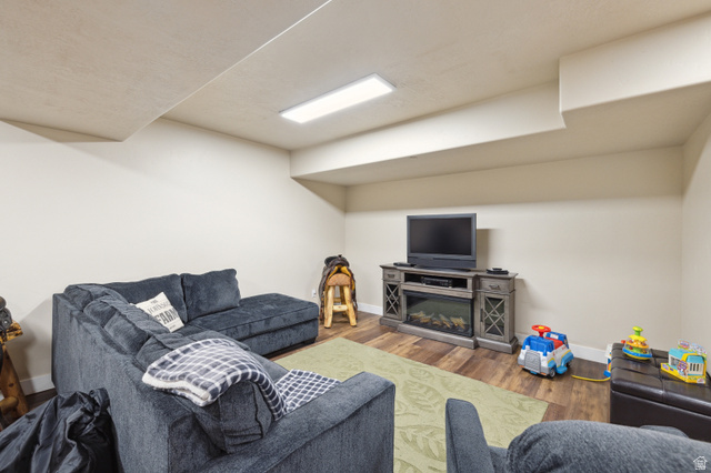 6117 North Rocky Ridge Road Peoa, UT 84061 - Photo 62 of 82 Recreation room featuring wood-finish flooring, a contemporary ceiling light fixture, and neutral wall tones