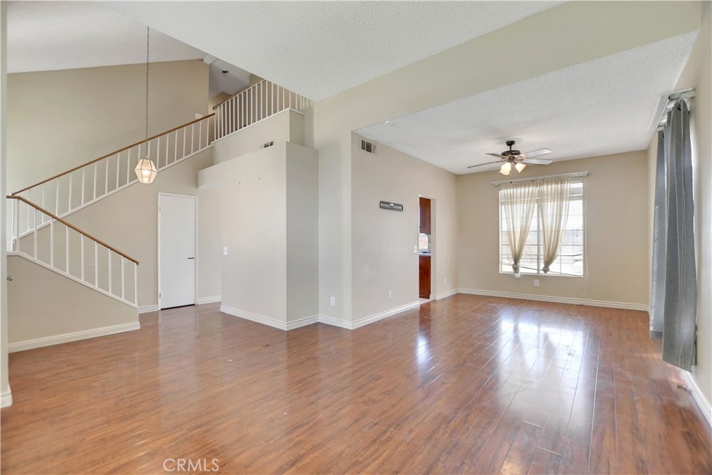 14527 Pony Trail Road Victorville, CA 92392 - Photo 16 of 21 a view of an empty room with wooden floor and a window