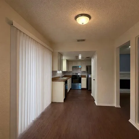 a view of a kitchen with a sink cabinets and outdoor space