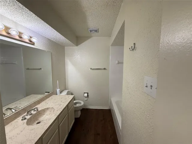 a spacious bathroom with a double vanity sink and a mirror