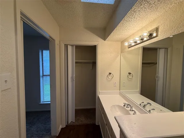 a bathroom with a tub sink and mirror