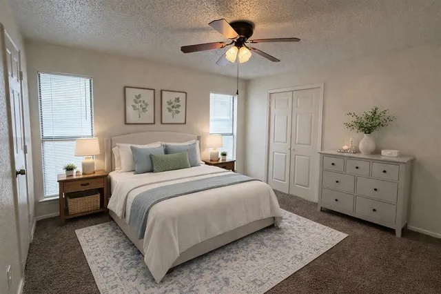 a bedroom with a large bed and a chandelier