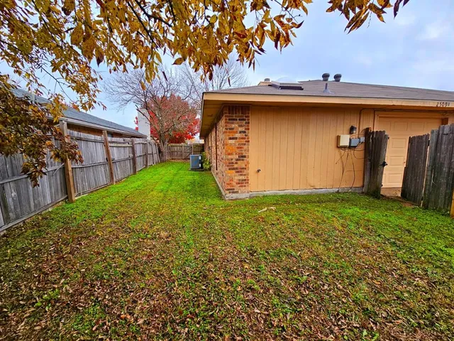 a view of a backyard with a large tree