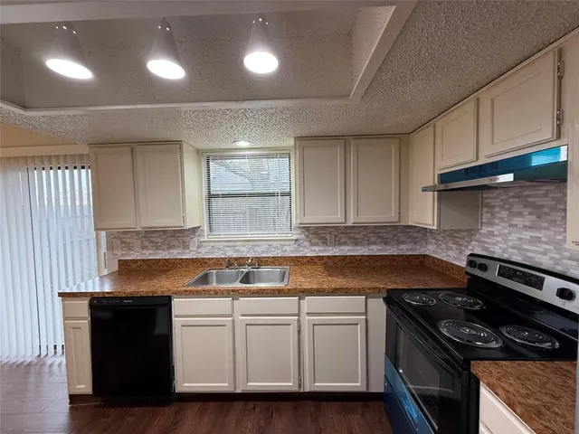 a kitchen with stainless steel appliances granite countertop a stove and a sink