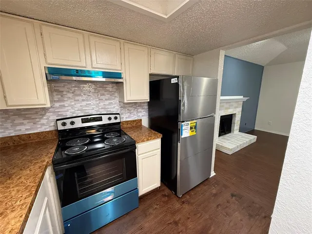 a kitchen with a stove and a refrigerator