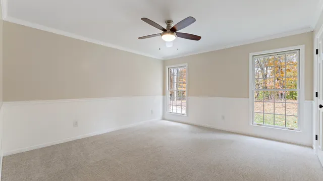 a view of a livingroom with wooden floor and window