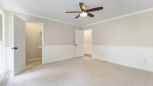 a view of a hallway with wooden floor and entryway