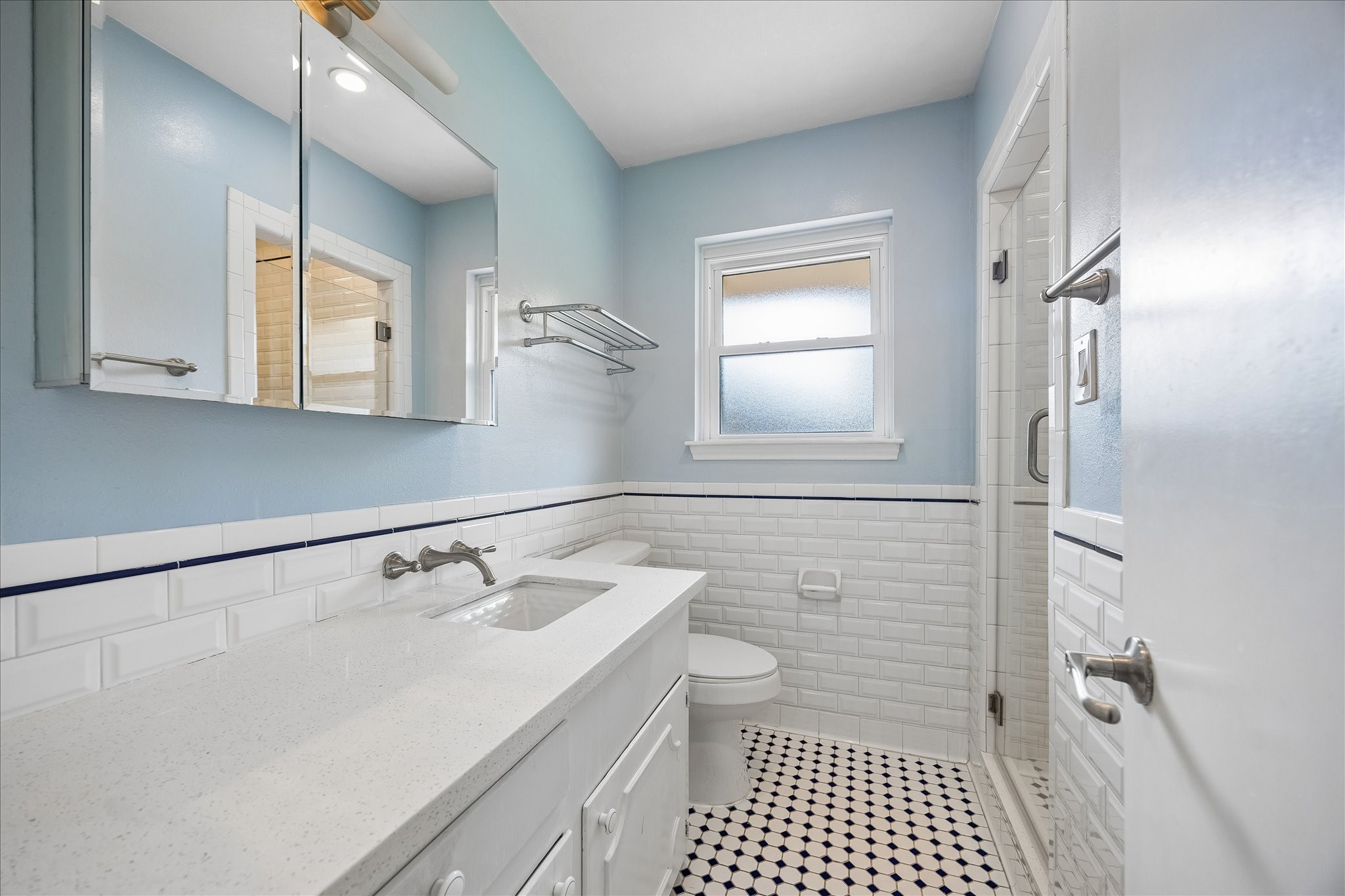 8922 Springview Lane Houston, TX 77080 - Photo 9 of 22 a bathroom with a sink a toilet and a mirror