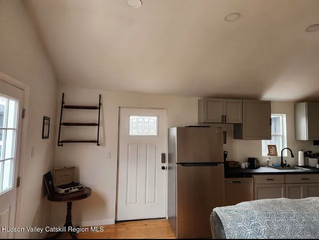 a kitchen with a refrigerator and a stove top oven