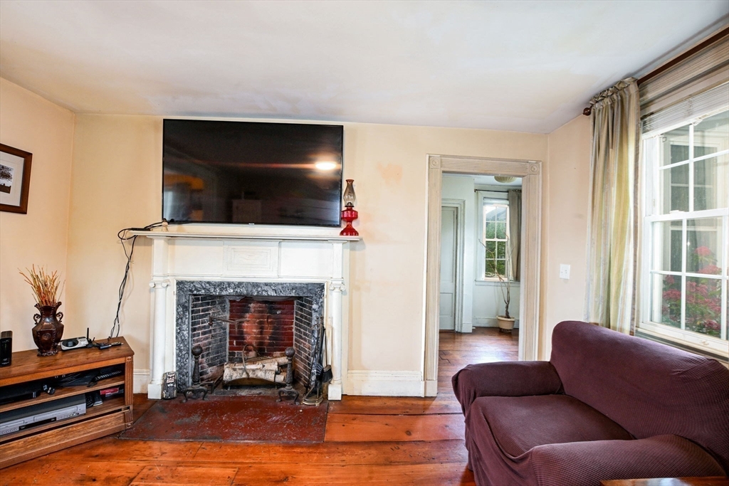 16 Middle Street Fairhaven, MA 02719 - Photo 10 of 34 a living room with furniture a flat screen tv and a fireplace