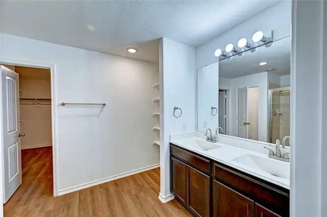 a bathroom with a double vanity sink and a mirror