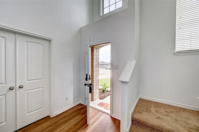a view of an entryway with wooden floor and windows