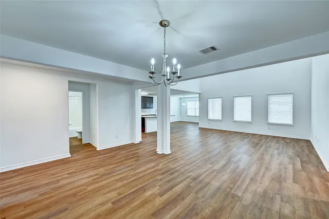 a view of a livingroom with wooden floor and a ceiling fan
