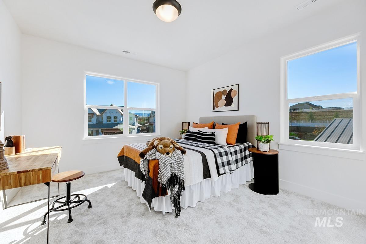 5817 South Gustav Avenue Meridian, ID 83642 - Photo 24 of 33 Bedroom featuring two large windows, white walls, and light-colored carpeting