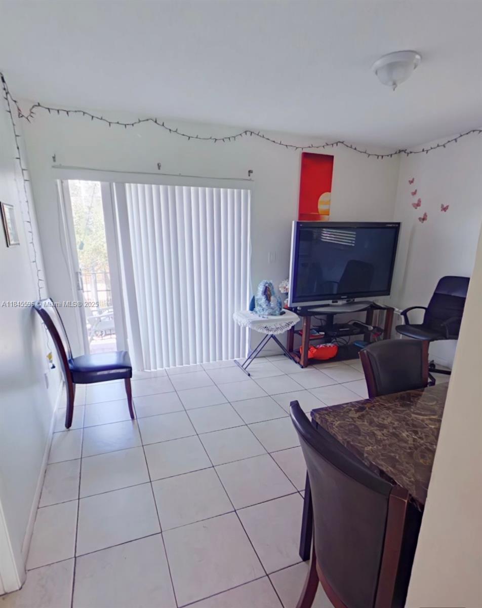 1068 Southwest 2nd Street Miami, FL 33130 - Photo 4 of 5 a living room with furniture and a flat screen tv
