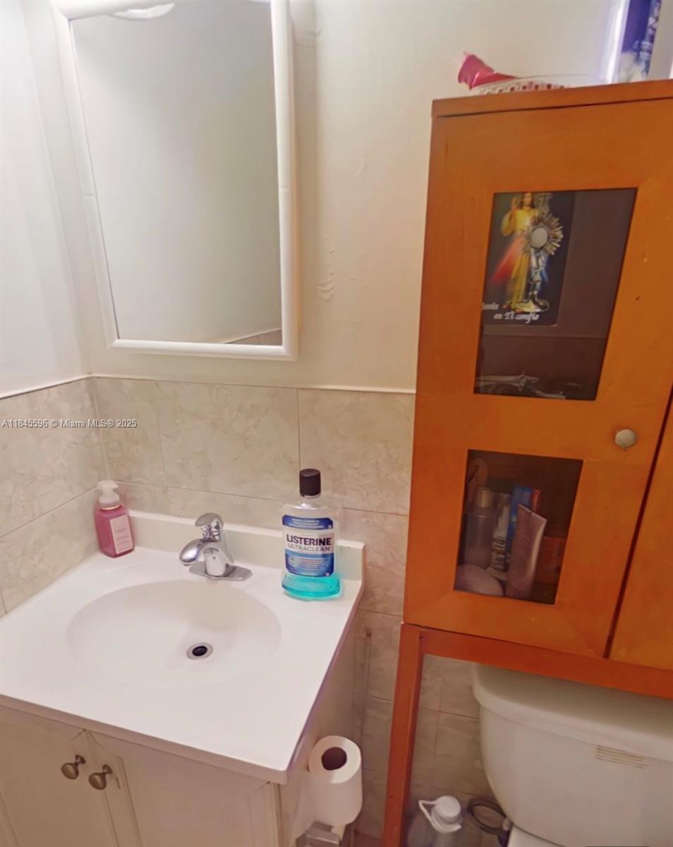 1068 Southwest 2nd Street Miami, FL 33130 - Photo 5 of 5 a bathroom with a sink and a mirror