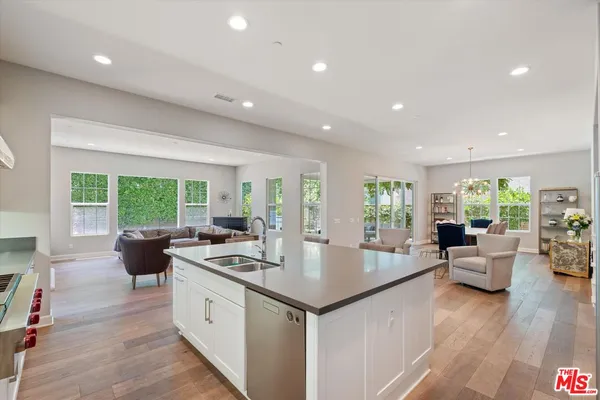 a kitchen with sink stove and cabinets