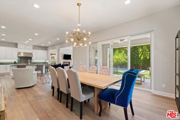 a living room with kitchen island furniture and a chandelier