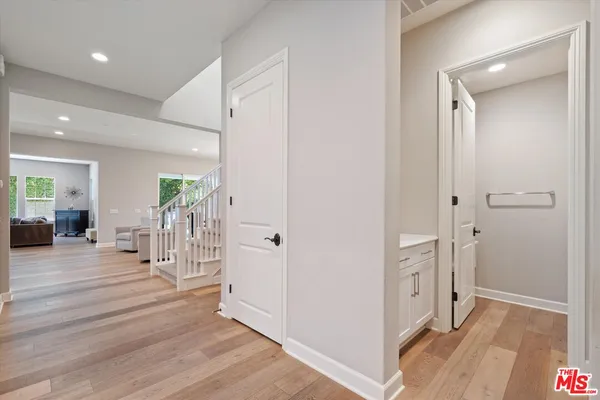 a view of entryway and hall with wooden floor