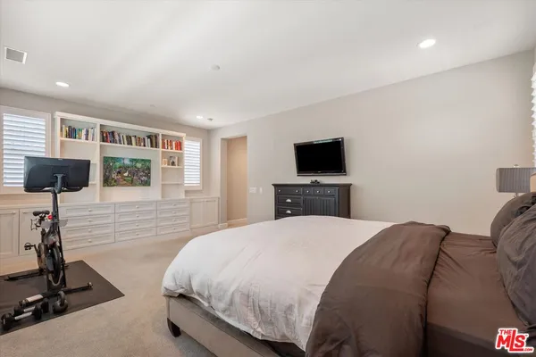 a large white kitchen with cabinets
