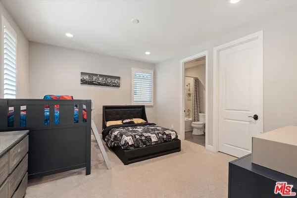 a bedroom with a bed and a desk