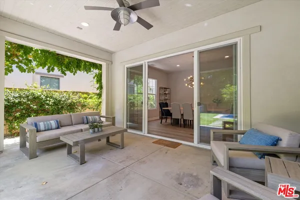 a view of a chairs and table in backyard of the house