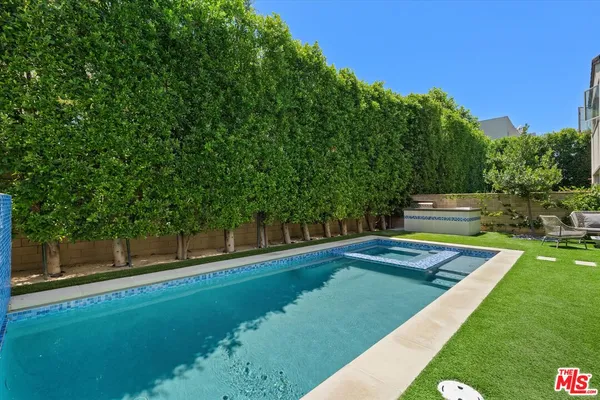 a view of a backyard with couches chair and grass
