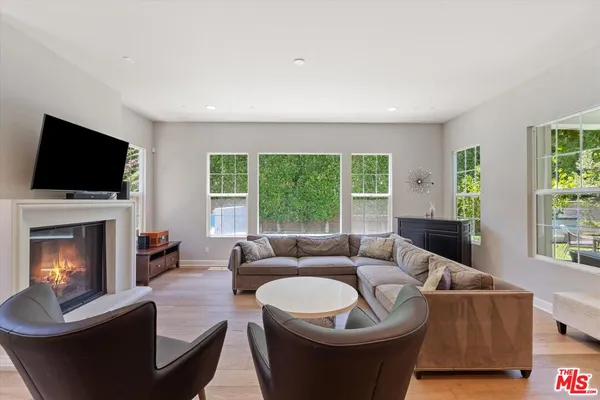 a living room with furniture fireplace and window
