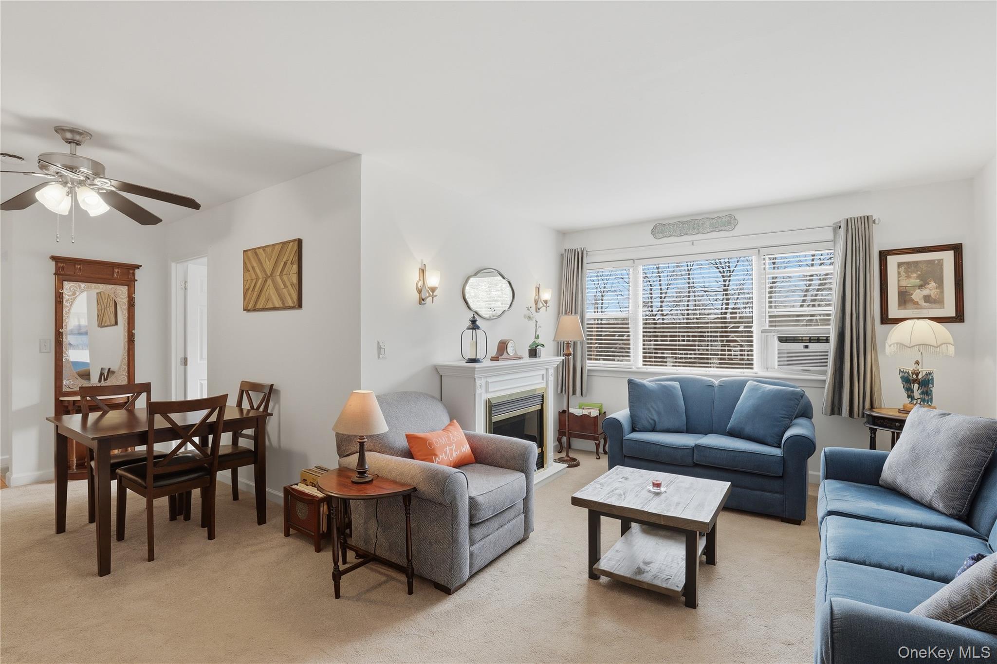352 North State Road, Unit 1H Briarcliff Manor, NY 10510 - Photo 6 of 20 a living room with furniture a chandelier and a window