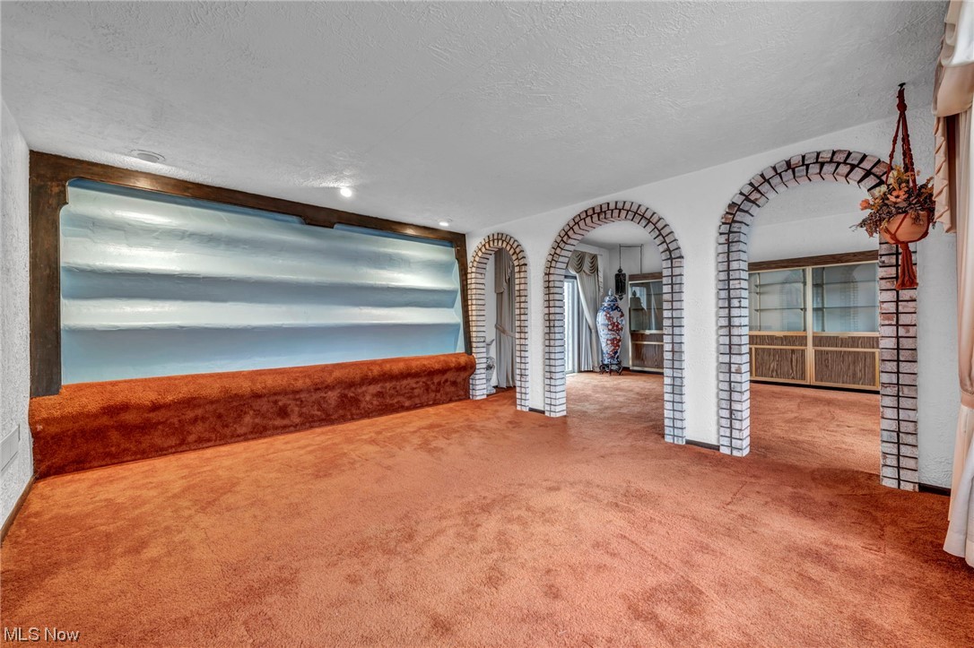 230 Crosse Road Amherst, OH 44001 - Photo 18 of 47 Unfurnished living room with light colored carpet and a textured ceiling
